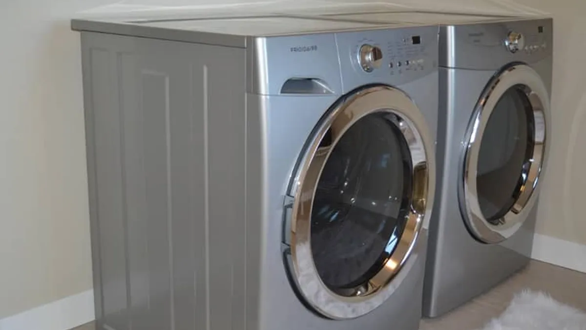 Residential clothes dryer in laundry room with clean exhaust vent line - diagnosing burning smell